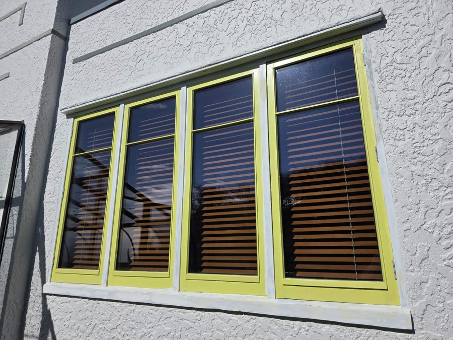 Crisp lime-green window frames on a white wall